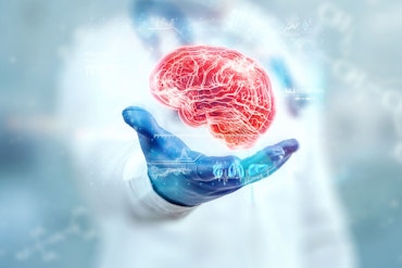 There is a brain floating in the hand of a scientist.