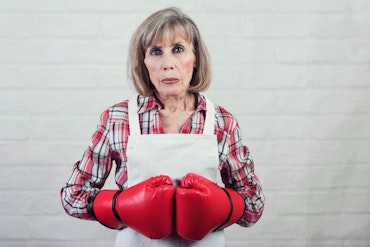 Older woman wearing boxing gloves