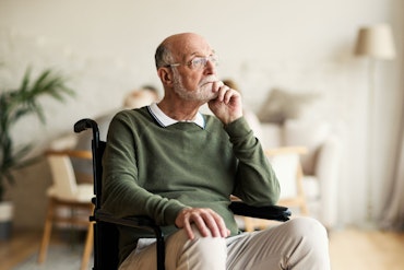 A man ponders while sitting in a wheelchair