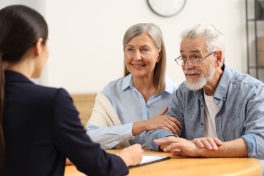 Two people look at a financial advisor