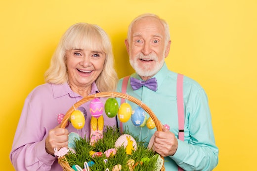 Two older adults hold an Easter basket