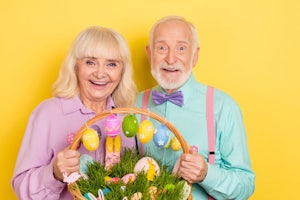 Two older adults hold an Easter basket