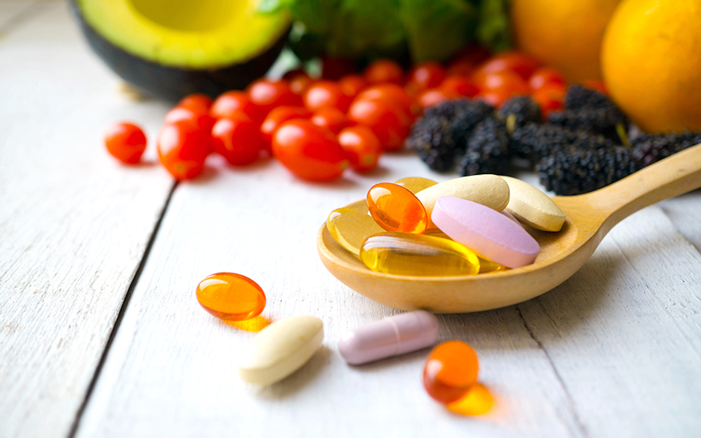 Dietary supplements on a wooden spoon 