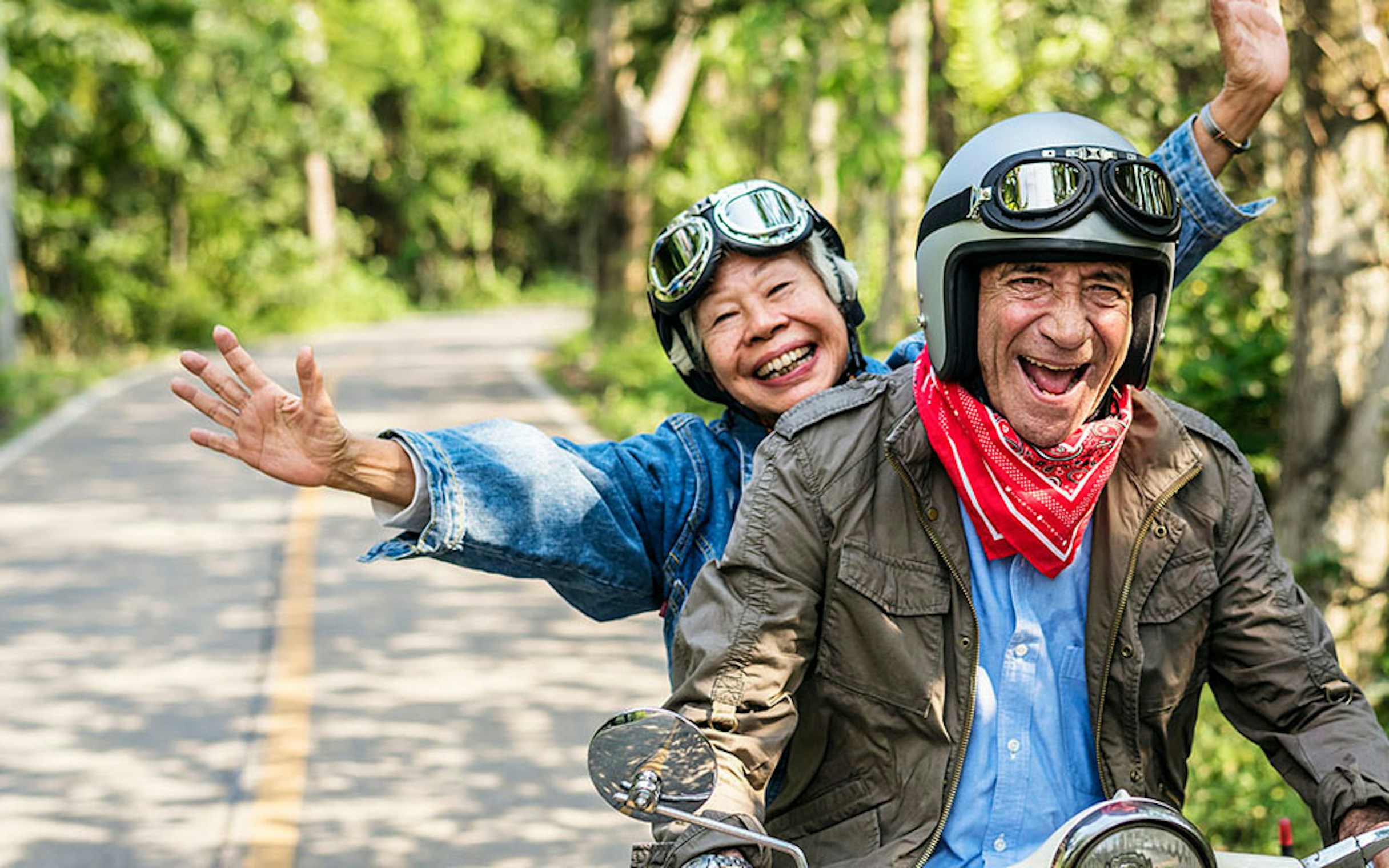 Senior couple riding a motorbike
