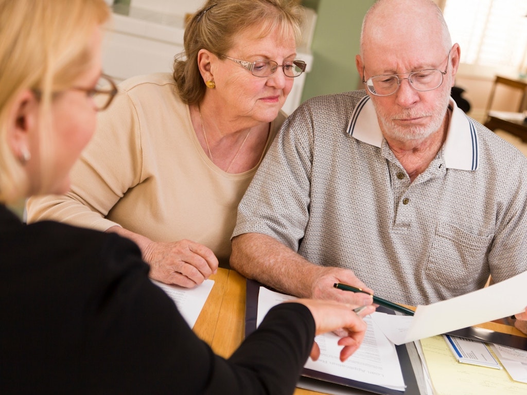 Older couple meeting with professional financial advisor.