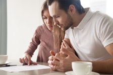Couple looks at life cover insurance form