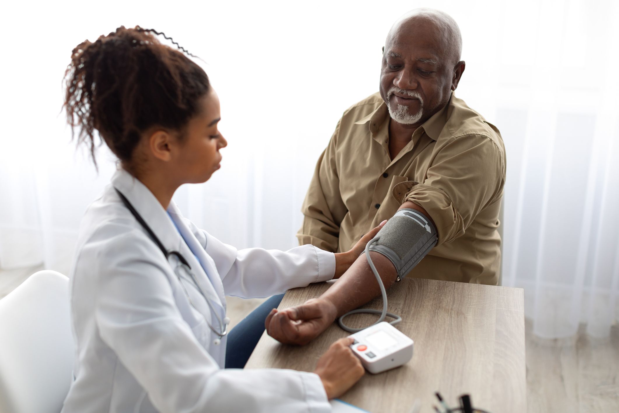 An old man is having a blood test by a doctor.