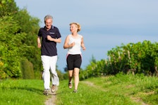 Retired couple jog together.