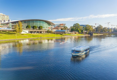A boat runs on the river in Adelaide City